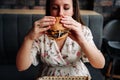 Hamburger girl eat. Pretty Young Happy Woman Eating Tasty Burger. Junk Food Concept. Royalty Free Stock Photo