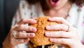 Hamburger girl eat. Pretty Young Happy Woman Eating Tasty Burger. Junk Food Concept. Royalty Free Stock Photo