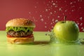 a hamburger and a green apple