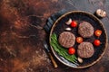 Hamburger grilled meat cutlets patties with herbs. Dark background. Top view. Copy space