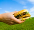 Hamburger in hand Royalty Free Stock Photo