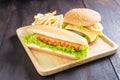 Hamburger, hot dog, french fries on the wood Royalty Free Stock Photo