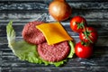 Hamburger iingredientes such as cheddar cheese, beef, onion, tomatoes, lettuce