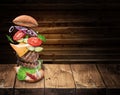 Hamburger ingredients falling down one by one to create a perfect meal. Colorful conceptual picture of burger cooking Royalty Free Stock Photo