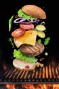 Hamburger ingredients falling down one by one to create a perfect meal. Colorful conceptual picture of burger cooking Royalty Free Stock Photo