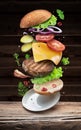 Hamburger ingredients falling down one by one to create a perfect meal. Colorful conceptual picture of burger cooking Royalty Free Stock Photo