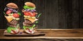 Hamburger ingredients falling down one by one to create a perfect meal. Colorful conceptual picture of burger cooking Royalty Free Stock Photo