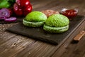 Hamburger ingredients on the table with space for text. Green buns for burger. Selective focus