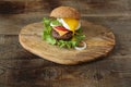 Hamburger isolated with fried egg on a wooden rustic background with copy space for text.