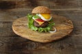 Hamburger isolated with fried egg on a wooden rustic background with copy space for text.