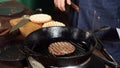 A hamburger patty frying on a cast iron grill. Stock footage. Hamburger Patty is prepared on the grill pan