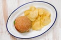 Hamburger with potato chips on white dish Royalty Free Stock Photo