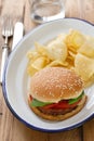 Hamburger with potato chips on white dish Royalty Free Stock Photo