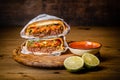 Hamburger or sandwich, beef torta with salsa dip and guacamole. Mexican cuisine