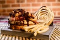 Hamburger sandwich with open brioche bread cream cheese fries bacon sauces on the table on blurred background