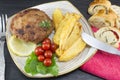 Hamburger steak with potatoes, cherry tomatoes and olive bread o Royalty Free Stock Photo