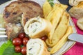 Hamburger steak with potatoes, cherry tomatoes and olive bread o Royalty Free Stock Photo