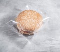 Hamburger in a transparent plastic box or nylon bag Royalty Free Stock Photo