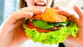 Hamburger vegan healthy vegetarian burger. Salad, avocado, vegetable on veggie sandwich eating cute woman. Tasty Royalty Free Stock Photo