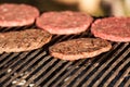 Hamburgers cooking on grill Royalty Free Stock Photo