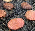 Hamburgers cooking on an outdoor grill Royalty Free Stock Photo