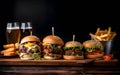 Hamburgers with french fries and beer on a wooden table Royalty Free Stock Photo