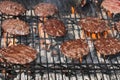 Hamburgers Grilling Over Flames Royalty Free Stock Photo