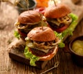 Hamburgers, homemade burgers with grilled buns with addition of addition of beef cutlet, lettuce, tomato,pickled cucumber, grille Royalty Free Stock Photo