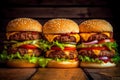 Hamburgers with two cutlets, lots of vegetables on a rustic wooden background. Toned.