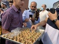 Men having Arabic sweets as a crowd Muslim worshippers gather outdoor at the Hamilton Mountain mosque to worship and celebrate Eid