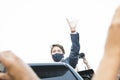 Prime Minister Justin Trudeau stands on vehicle and waves to a crowd of supporters in Hamilton.