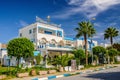 HAMMAMET, TUNISIA - Oct 2014: Street with date palms, trees and white buildings on October 6, 2014