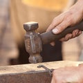 Hammer, anvil and the hands of blacksmith Royalty Free Stock Photo