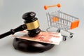 Hammer of auctioneer with pushcart and money on gray Royalty Free Stock Photo