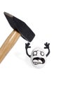 Hammer beat the egg with smiley Royalty Free Stock Photo