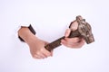 Hammer in the hand of a girl. Symbol of hard work, feminism and labor day. Isolate on white background