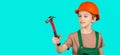 Hammer in hand of small boy repairing in workshop. Foreman inspector. Little man in helmet with hammer. Kid worker in Royalty Free Stock Photo