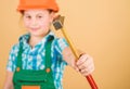 Hammer in hand of small girl repairing in workshop. Foreman inspector. Little girl in helmet with hammer. Kid worker in Royalty Free Stock Photo