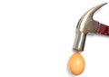 Hammer hitting a cracked egg isolated on white Royalty Free Stock Photo