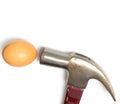 Hammer hitting an egg on white Royalty Free Stock Photo