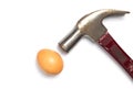 Hammer hitting an egg on white background. Royalty Free Stock Photo