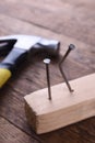 Hammer iron,centimeter tape and nails on wooden background