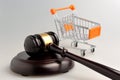 Hammer of judge and pushcart on gray Royalty Free Stock Photo