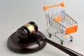 Hammer of judge and pushcart on gray Royalty Free Stock Photo