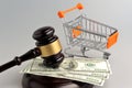Hammer of judge, pushcart and money on gray Royalty Free Stock Photo