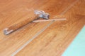 Hammer and laminate plank on floor