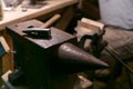 The hammer lies on the anvil in the workshop
