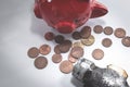 The hammer lies next to a red piggy bank and a bunch of small euro coins. Top view. The concept of finding money, shopping, crisis