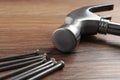 Hammer and metal nails on wooden table, closeup Royalty Free Stock Photo