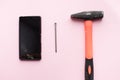 Hammer and mobile phone with broken display Royalty Free Stock Photo